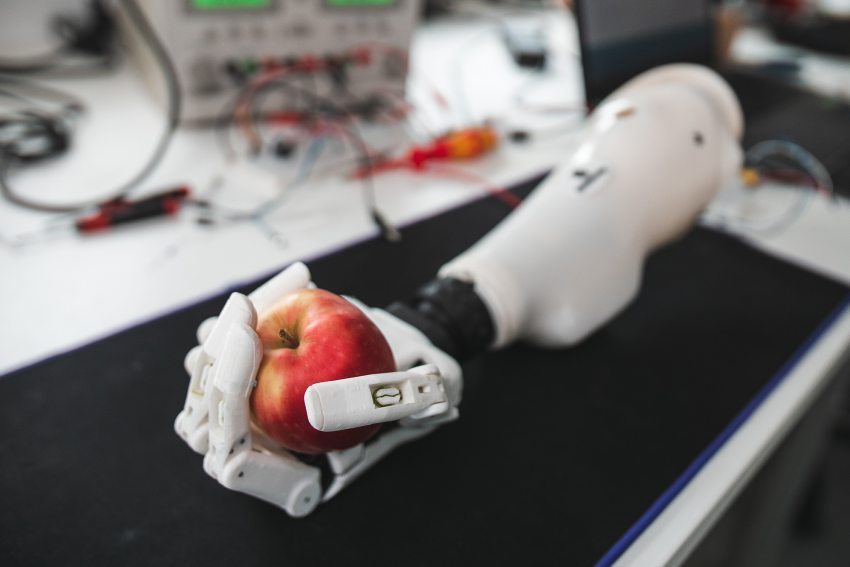 A 3D printed arm holding an apple