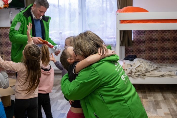 A child from the children's home hugging a social worker of the Hungarian Reformed Church Aid