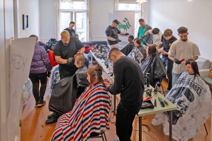 Volunteer hairdressers cutting hair for Ukranian refugees